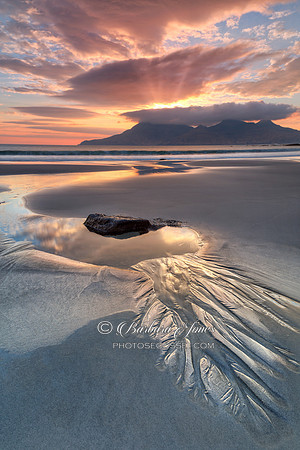 Isle of Eigg. Singing Sands. Sunset Rock Pool and sand patterns. Scotland.